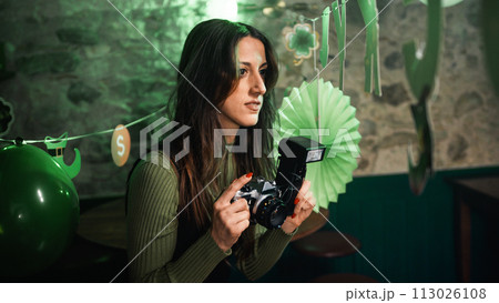 Girl takes pictures with camera in a party Girl takes pictures with camera in a party 113026108