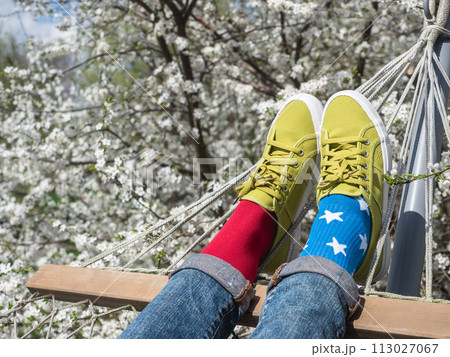 Trendy sneakers and colorful socks. Closeup, outdoors Trendy sneakers and colorful socks. Closeup, outdoors 113027067