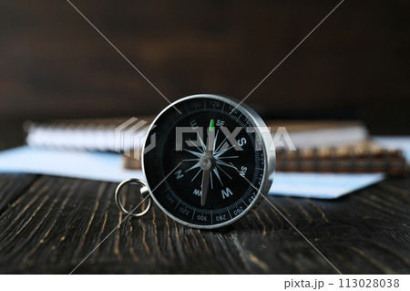 A compass on a table with an airplane. A compass on a table with an airplane. 113028038