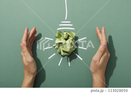 A light bulb made of crumpled paper, the concept of an eco house A light bulb made of crumpled paper, the concept of an eco house 113028050