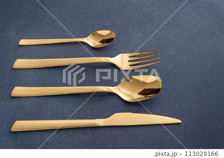 Set of cutlery made of gold metal. Fork, spoon, knife, teaspoon. Set of cutlery made of gold metal. Fork, spoon, knife, teaspoon. 113028166