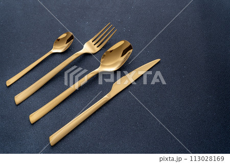Set of cutlery made of gold metal. Fork, spoon, knife, teaspoon. Set of cutlery made of gold metal. Fork, spoon, knife, teaspoon. 113028169
