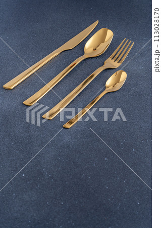 Set of cutlery made of gold metal. Fork, spoon, knife, teaspoon. Set of cutlery made of gold metal. Fork, spoon, knife, teaspoon. 113028170
