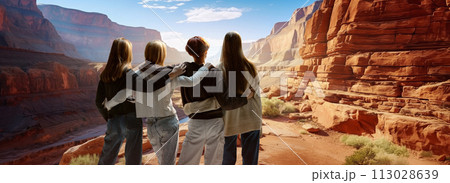 Four people, friends stand and admire view, landscapes. Deep, sandy canyon lit by pleasant daylight. 113028639