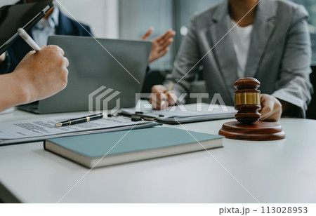 Teamwork of business lawyer meeting working hard about legal legislation in courtroom to help their customer. Teamwork of business lawyer meeting working hard about legal legislation in courtroom to help their customer. 113028953