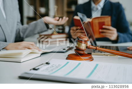 Teamwork of business lawyer meeting working hard about legal legislation in courtroom to help their customer. 113028956