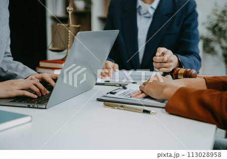 Teamwork of business lawyer meeting working hard about legal legislation in courtroom to help their customer. 113028958