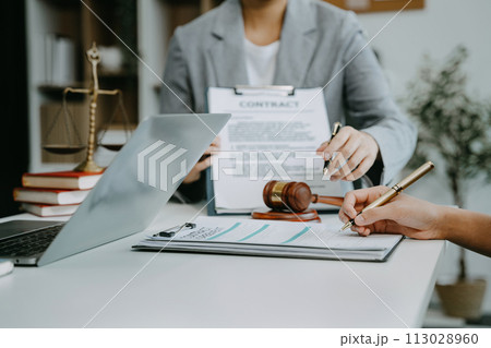 Legal counsel presents to the client a signed contract with legal law. justice and lawyer concept in office. Legal counsel presents to the client a signed contract with legal law. justice and lawyer concept in office. 113028960