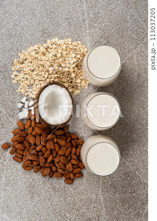 Types of plant-based milk in glasses. Oat, coconut and almond milk. 113037205