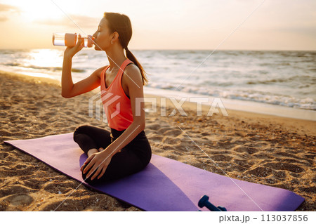 Young woman in sportswear doing yoga, fitness exerciseon the beach. Sport, Active life. Young woman in sportswear doing yoga, fitness exerciseon the beach. Sport, Active life. 113037856