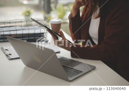 Shot of a asian young business Female working on laptop in her workstation. 113040040