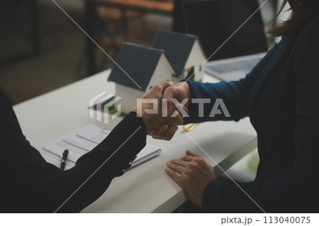 Business Signing a Contract Buy - sell house, insurance agent analyzing about home investment loan Real Estate concept. Business Signing a Contract Buy - sell house, insurance agent analyzing about home investment loan Real Estate concept. 113040075