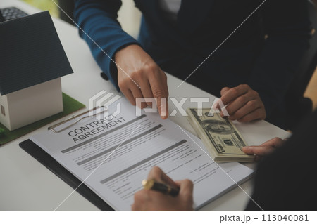 Business Signing a Contract Buy - sell house, insurance agent analyzing about home investment loan Real Estate concept. 113040081