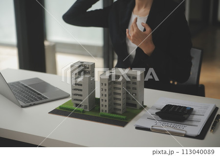 Business Signing a Contract Buy - sell house, insurance agent analyzing about home investment loan Real Estate concept. 113040089