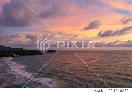 .aerial view Wave after wave swept towards the shore at sunset. 113040220