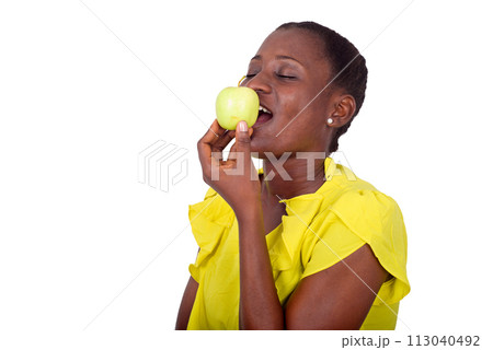 portrait of young girl with apple. 113040492