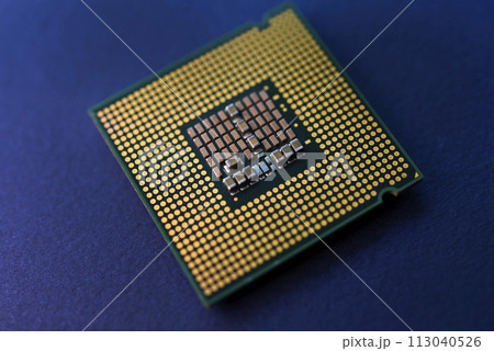 A computer processor on a blue background. Contacts on the processor case. 113040526
