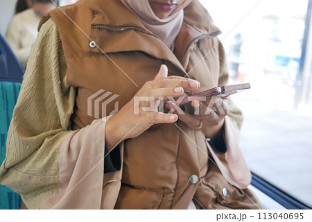 young women using smart phone inside of metro train  113040695