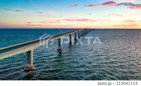 Confederation Bridge to Prince Edward Island. Vibrant sunny sunrise. Confederation Bridge to Prince Edward Island. Vibrant sunny sunrise. 113041114