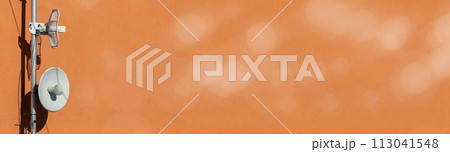 Two telecommunications antennas used for cellular network and wireless Internet, fixed on the building wall. Receiving and digitizing multiple pieces of information at once. Panoramic frame. Bokeh 113041548