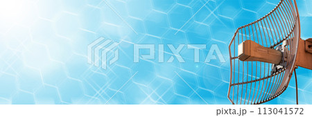 Mesh antenna for cellular telecommunications network and wireless internet against a blue sky. Receiving and digitizing multiple pieces of information at once. In the sunshine. Panoramic frame. 113041572