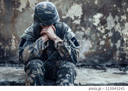 Distressed Soldier Sitting With Head in Hands. June 27, Post-Traumatic Stress Disorder,PTSD, Awareness Day 113043241