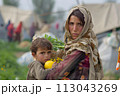 Woman Holding Child in Arms. June 20, World Refugee Day 113043269