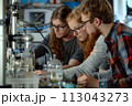 Group of People Examining Object on Table. DNA, biohacking 113043273