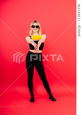 Young woman with roller brush on red white background Instruments accessories for renovation room Young woman with roller brush on red white background Instruments accessories for renovation room 113043336