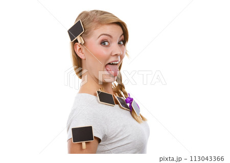 Teenage girl having little blackboards in hair Teenage girl having little blackboards in hair 113043366