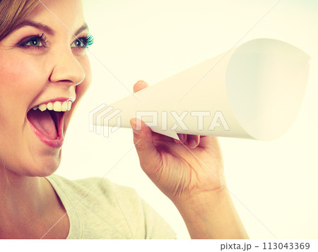 Woman screaming through megaphone made of paper 113043369