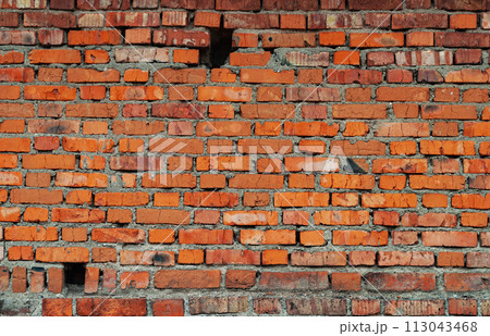 Old brick wall with holes 113043468