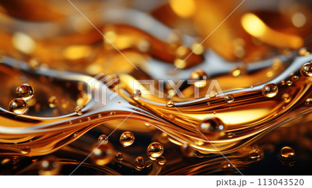Oil drops on water. Oil spheres floating in a golden liquid. Bubbles of different sizes on orange abstract background 113043520