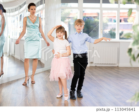 Boy and girl train to dance contemporary vigorous rumba during classes. Boy and girl train to dance contemporary vigorous rumba during classes. 113045641