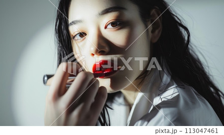 The picture of red lips young beautiful asian woman looking at camera . AIGX01. 113047461