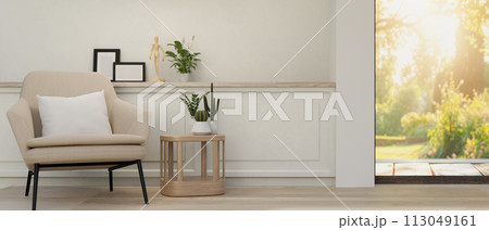 The interior design of a contemporary living room features a modern armchair and a coffee table. 113049161