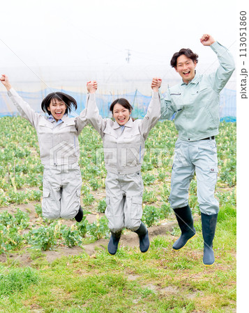 手をつないでジャンプする農作業服の若者たち 手をつないでジャンプする農作業服の若者たち 113051860