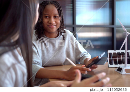 Group of international or multi ethnicity student having a discussion together about science project in class room. 113052686