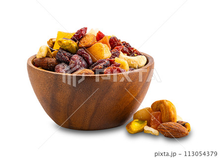 Breakfast mix nuts and fruits in wooden bowl and pile on the floor. Breakfast mix nuts and fruits in wooden bowl and pile on the floor. 113054379