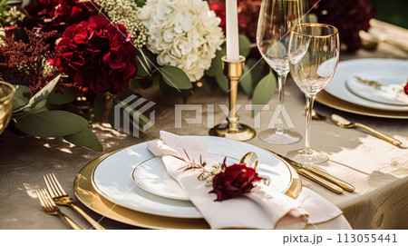Wedding or formal dinner holiday celebration tablescape with hydrangea flowers in the English countryside garden, table setting and wine, floral table decor for family dinner party, home styling 113055441