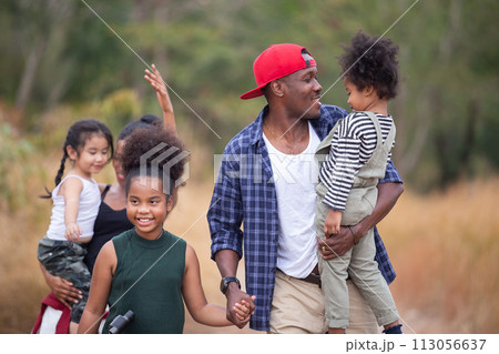 Happy mixed race family, father mother and children travel and camping walking on mountain gold meadow, Travel concept. Parent childhood cheerful trip adventure forest walking. Happy mixed race family, father mother and children travel and camping walking on mountain gold meadow, Travel concept. Parent childhood cheerful trip adventure forest walking. 113056637
