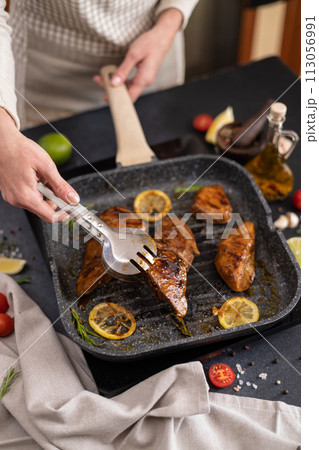 marinated pieces of Organic Tuna Steak frying on a hot grill pan marinated pieces of Organic Tuna Steak frying on a hot grill pan 113056991