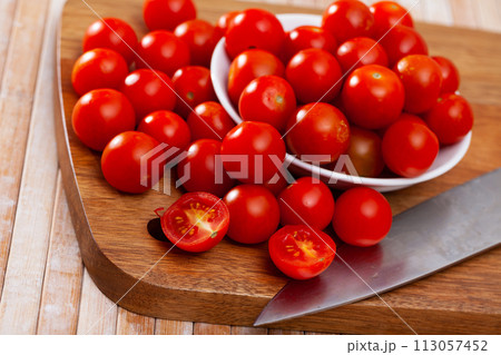 Close up of red cherry tomato on table Close up of red cherry tomato on table 113057452
