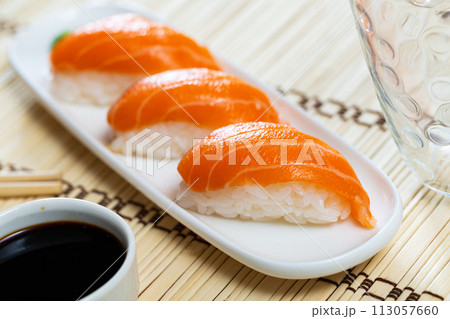 Sushi sake nigiri with salmon served on platter 113057660