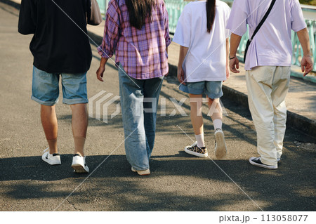 Crop image of young people walking on street Crop image of young people walking on street 113058077