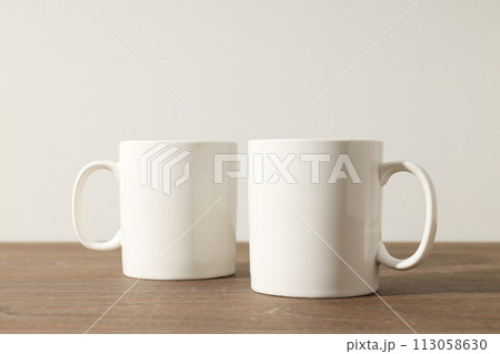 White beautiful cups on a wooden table 113058630