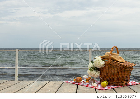 The concept of a picnic by the sea, with flowers. 113058677
