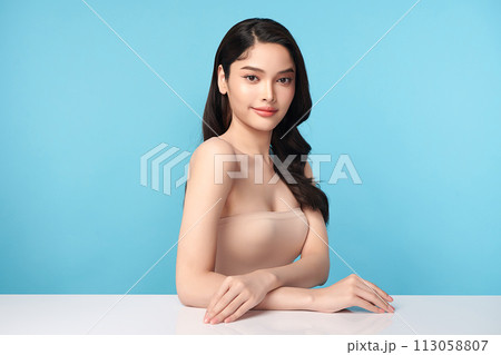 Beautiful Young transgender woman with clean fresh skin on blue background, Face care, Facial treatment, Cosmetology, beauty and spa, transgender women portrait. 113058807