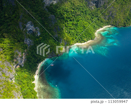 Pasandigan Cove with boats over clear water. Cadlao Island. El Nido, Palawan. Philippines. 113059947