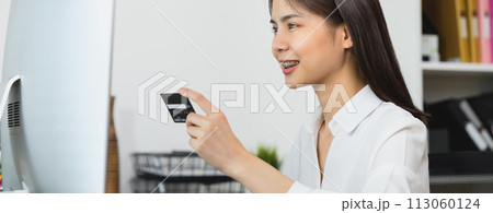 female hand holding credit card and type on laptop keyboard with online payment for shopping. female hand holding credit card and type on laptop keyboard with online payment for shopping. 113060124